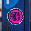 square-pink-antsy-round-sticker-on-a-blue-parking-meter
